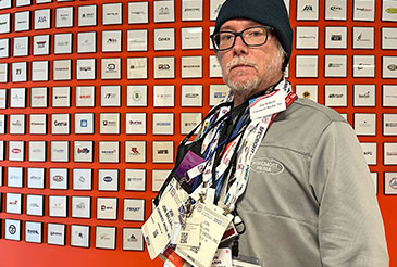 We know how to market at Trade Shows - man with trade show badge